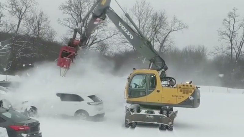 Watch Volvo excavator clear snowy cars in seconds with industrial blower
